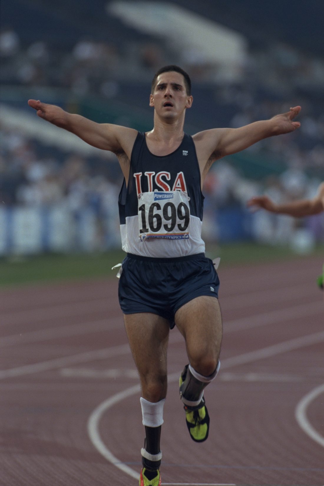 Tony Volpentest crossing the finish line, arms outstretched